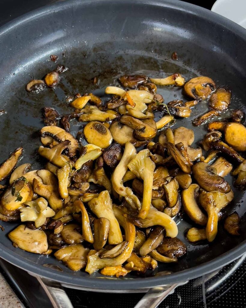 Rendered down mushrooms in a skillet.