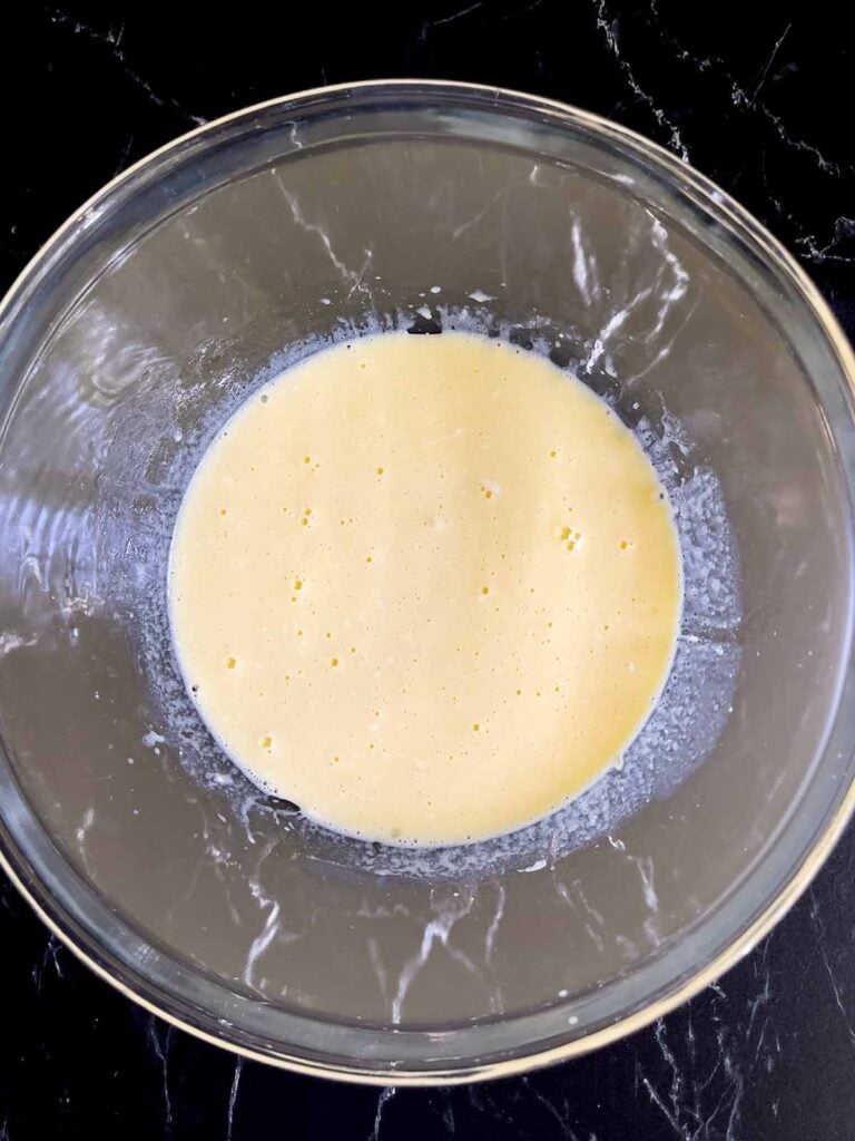 Wet ingredients for Mississippi Mud Cake combined in a glass mixing bowl.