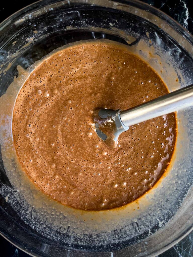 Mississippi Mud Cake batter mixed together in a glass mixing bowl.