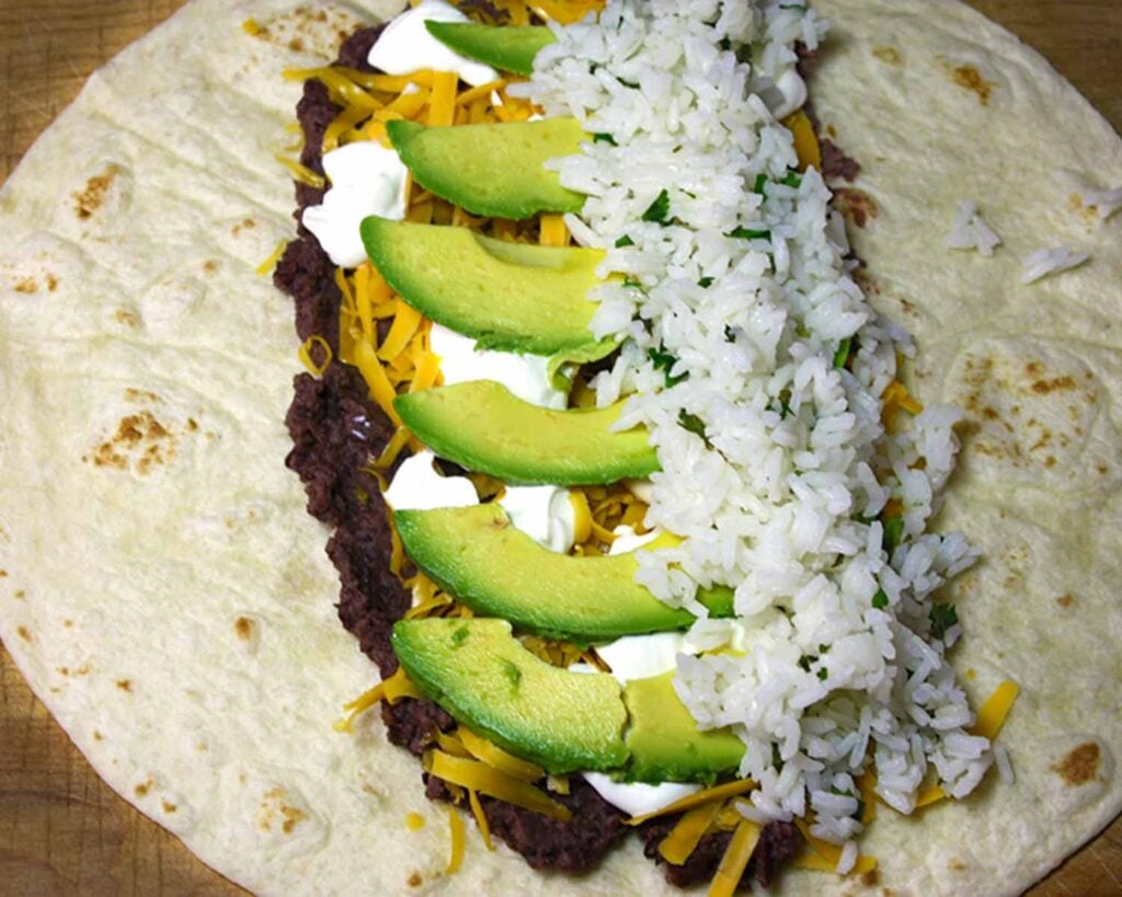 Vegetarian burrito being assembled.