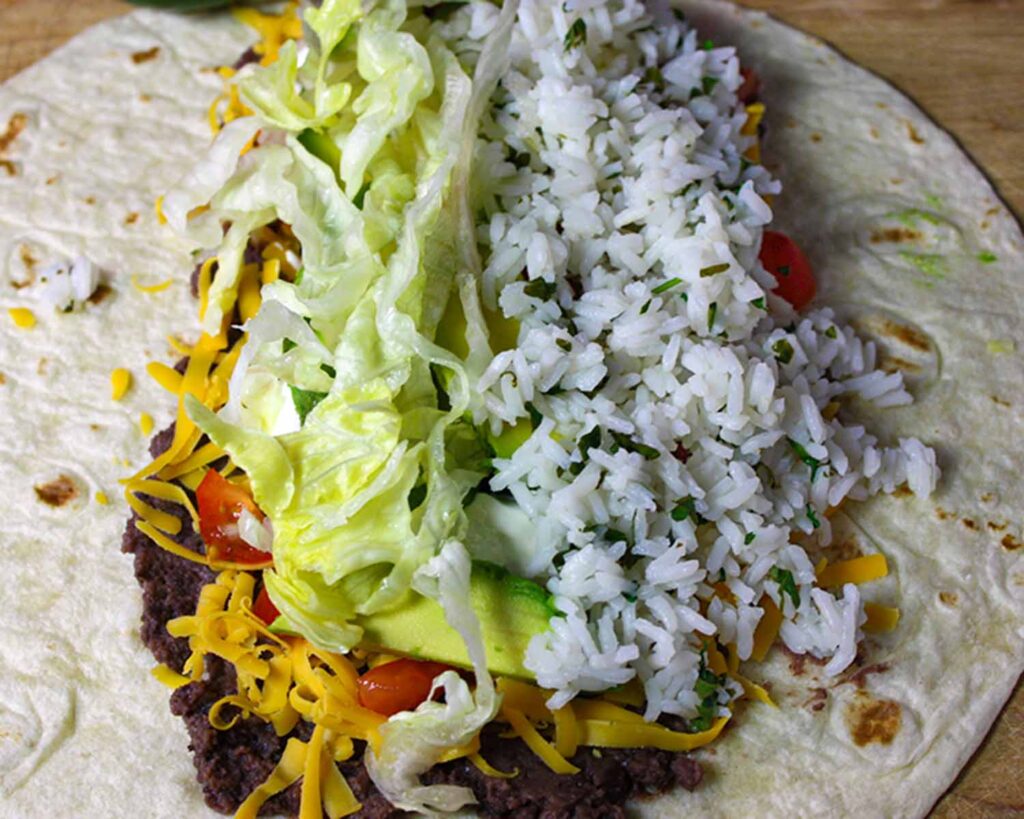 Vegetarian burrito being assembled.