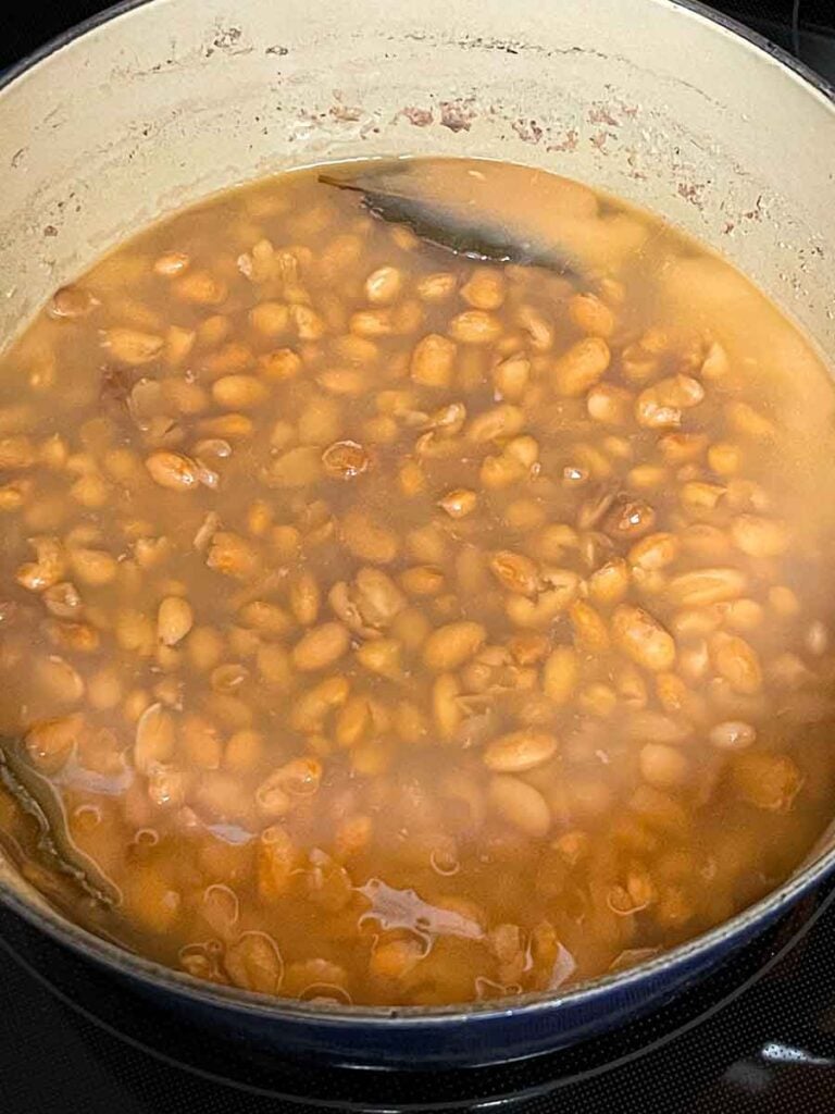 Pinto beans cooking in a dutch oven.