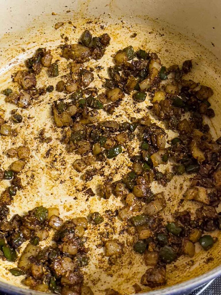 Herbs and onions cooked down in a dutch oven.