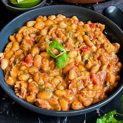 Borracha beans (drunken beans) in a dark bowl.