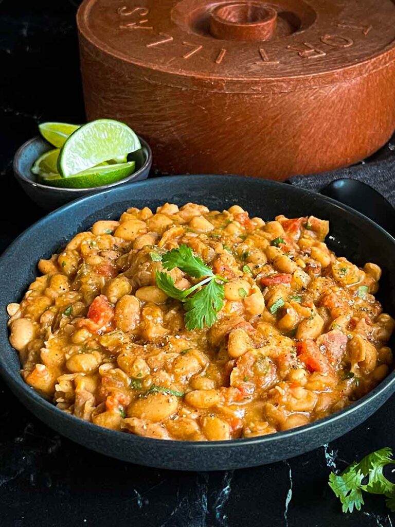 Borracha beans (drunken beans) in a dark bowl.