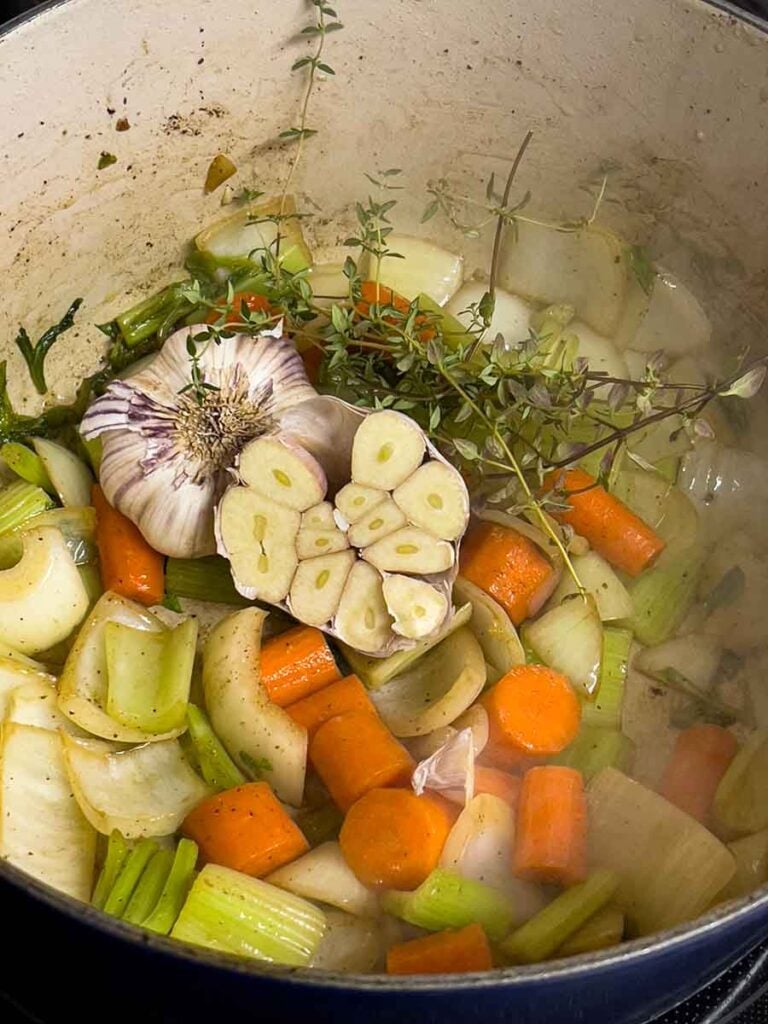 Vegetables, for the braised beef, cooking in a dutch oven.