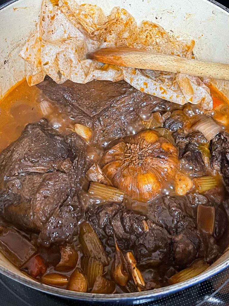 Braised beef cheeks in a dutch oven.