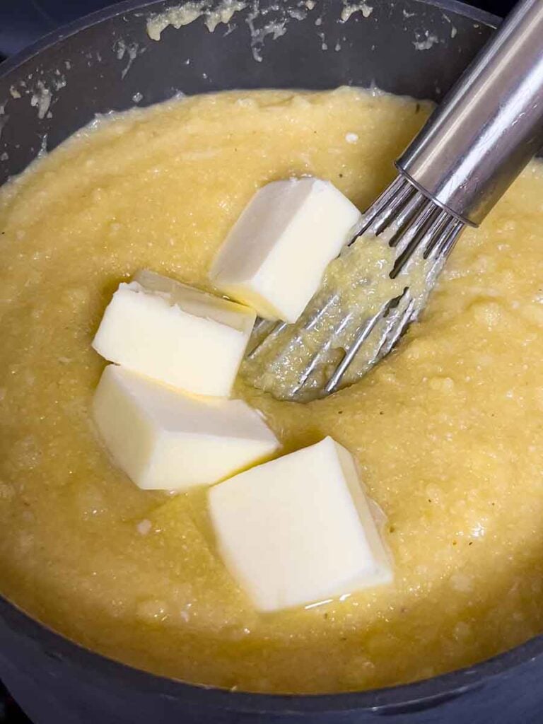 Adding butter to polenta.