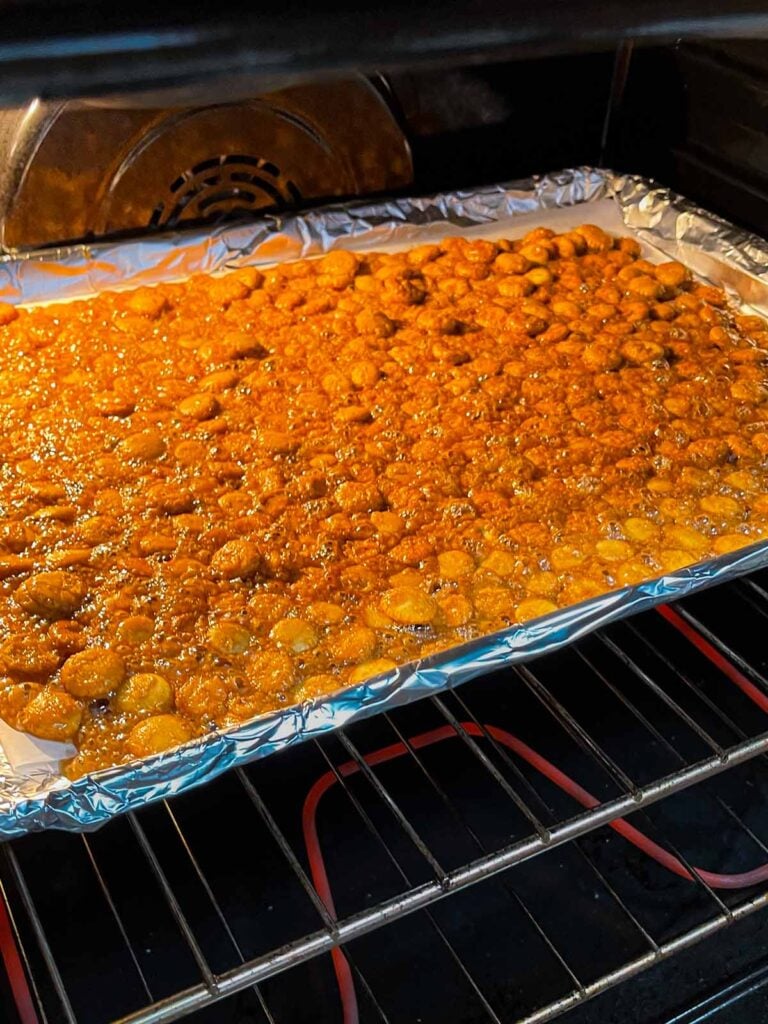 The oyster cracker churro snack mix baking in the oven.