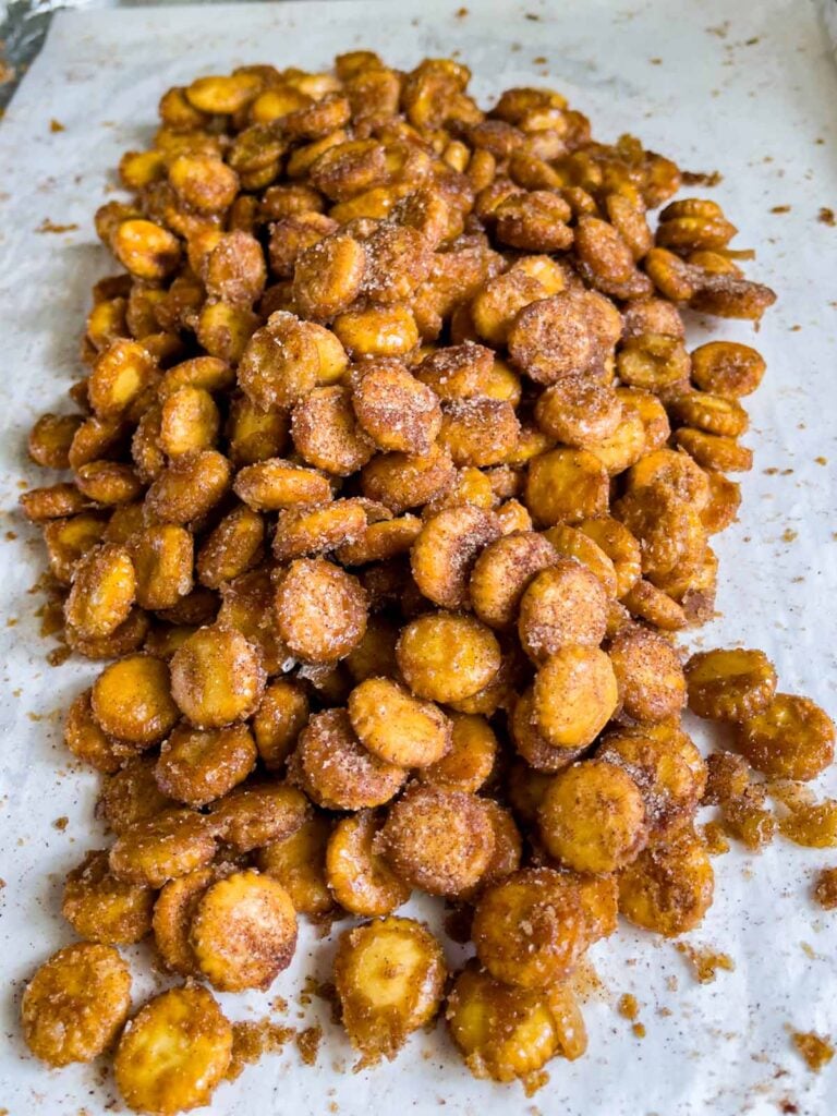 Oyster cracker churro snack mix broken up on a baking sheet.