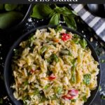 Spinach and Feta Orzo Salad in a dark bowl on a dark surface.