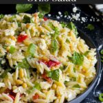 Spinach and Feta Orzo Salad in a dark bowl on a dark surface.