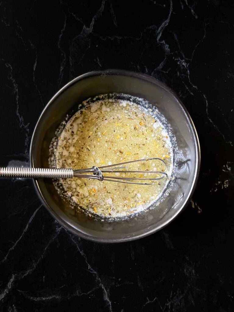 A butter herb mixture in a small bowl.