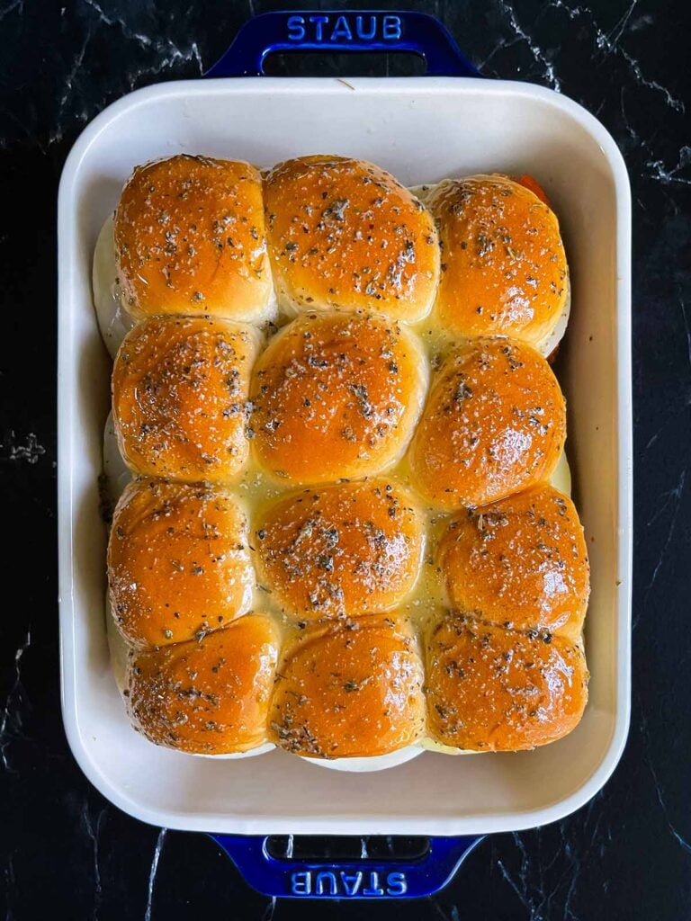 Chicken parmesan sliders in a 9x13 inch pan ready to be baked.