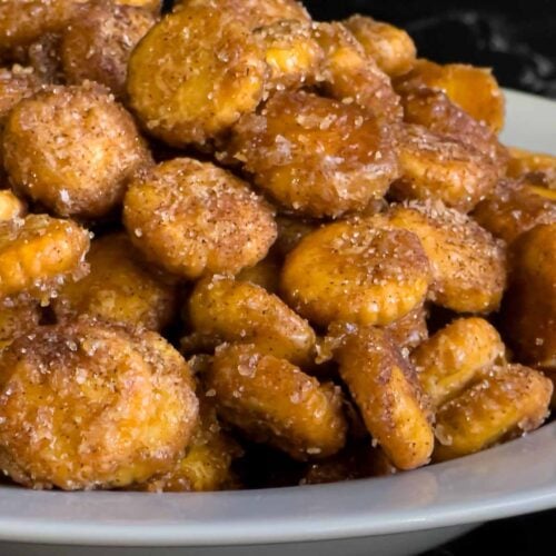 Churro snack mix piled high in a white bowl.