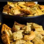 Dill Pickle Chex Mix in a three dark bowls on a light linen napkin.