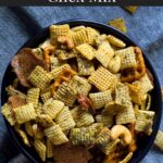 Dill Pickle Chex Mix in a dark bowl on a light linen napkin.