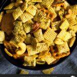 Dill Pickle Chex Mix in a dark bowl on a light linen napkin.