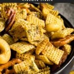 Dill Pickle Chex Mix in a dark bowl on a light linen napkin.