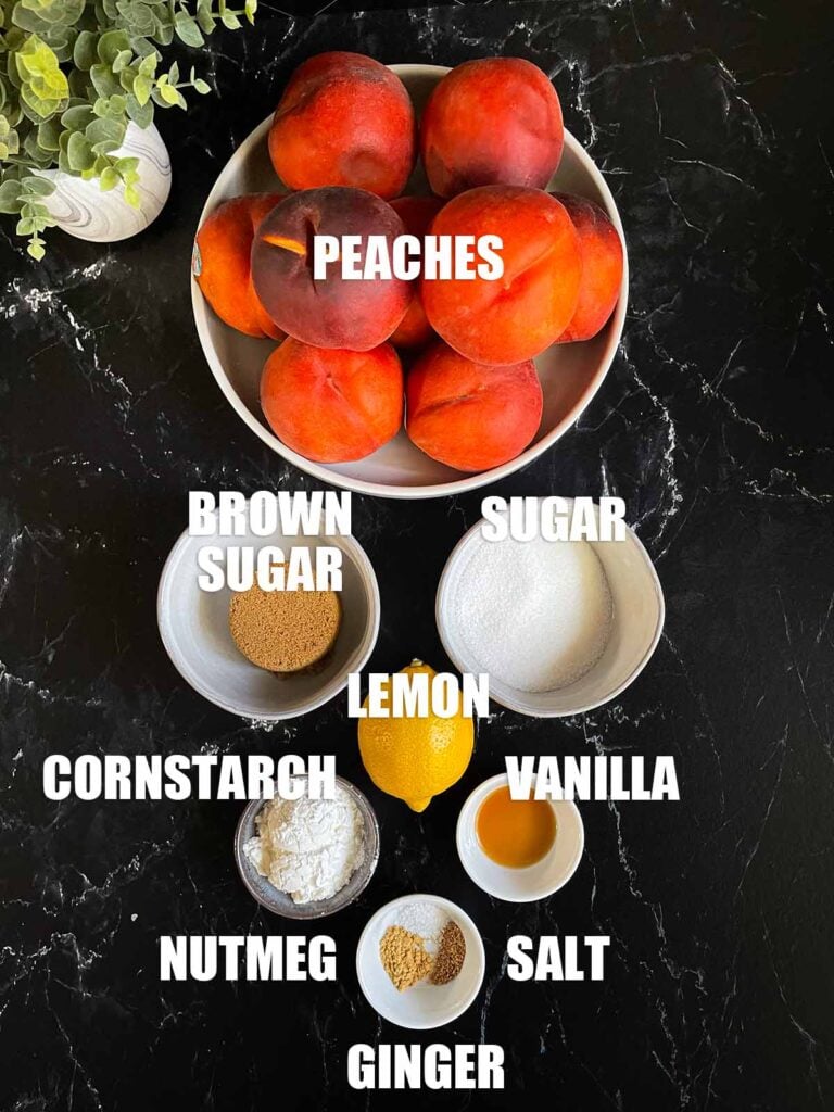 Peach pie ingredients on a dark surface.
