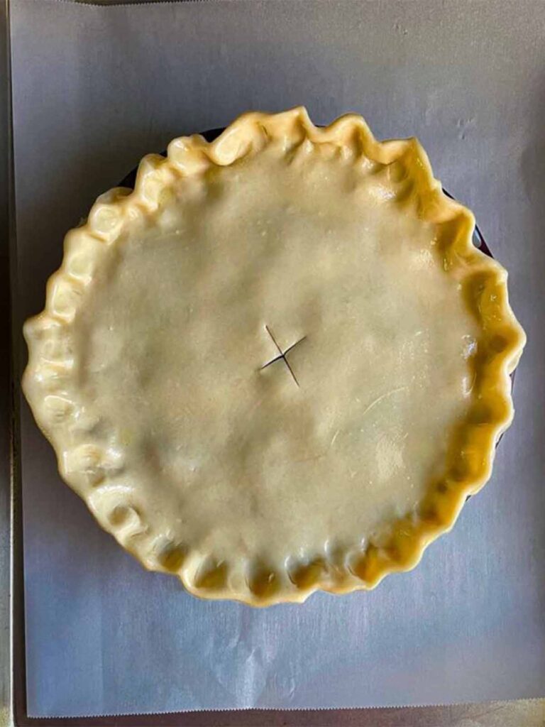 Pie dough on top of pie.