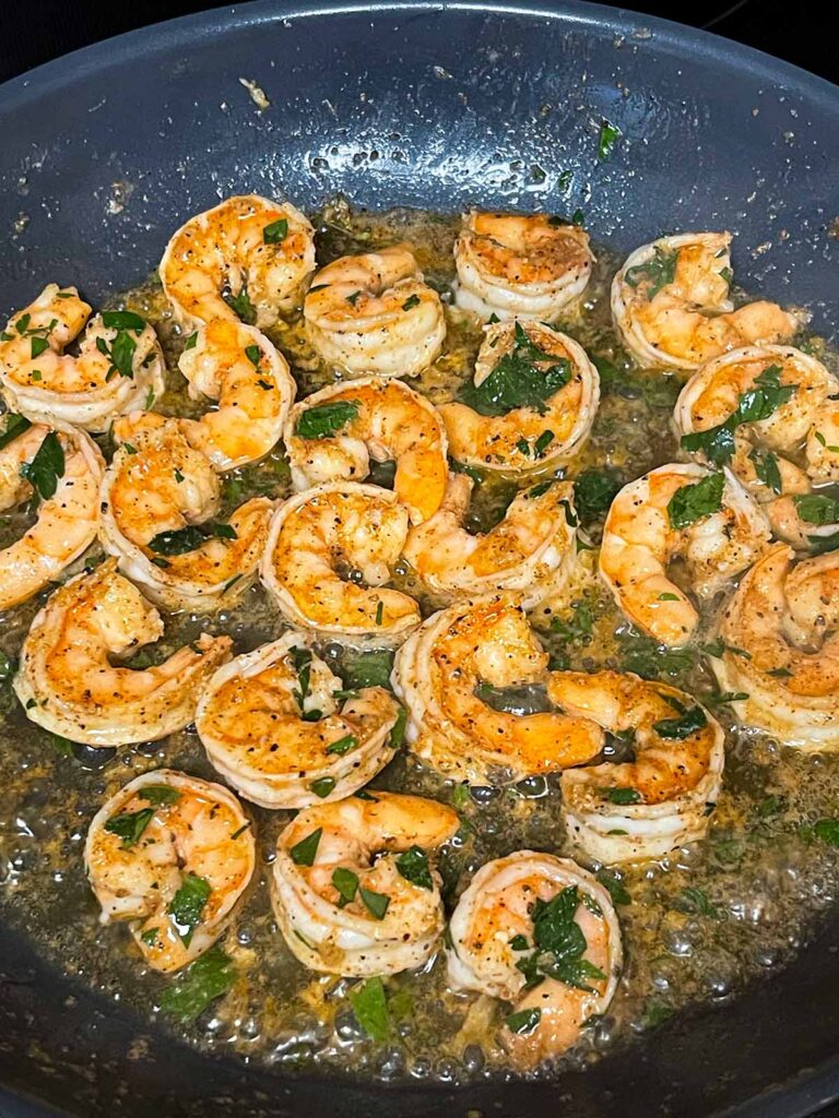 Cooked shrimp in a skillet.