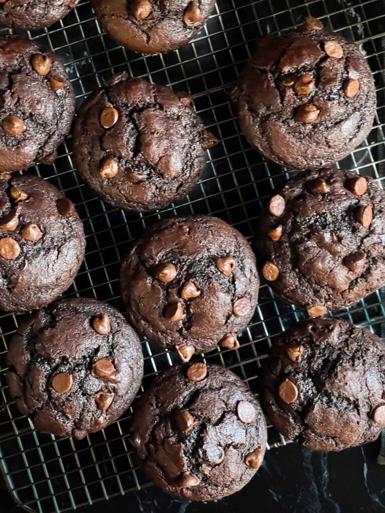 Double chocolate muffins on a cooling rack.