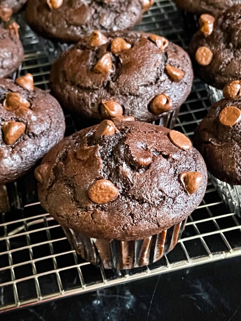 Double chocolate muffins on a cooling rack.