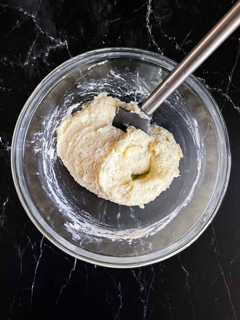 Mashed potatoes in a glass bowl.