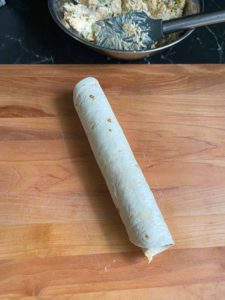 A rolled up Jalapeno Popper pinwheel, uncut.