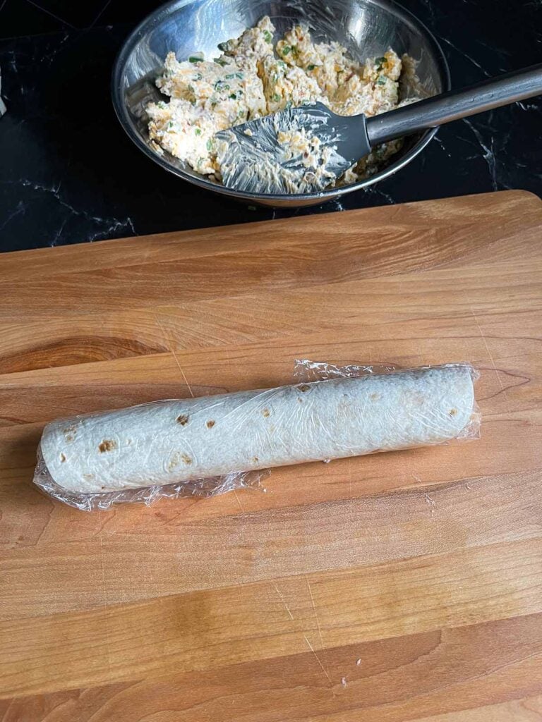 Plastic wrapped Jalapeno popper pinwheel, uncut.