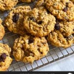 Baked old fashioned oatmeal raisin cookies on a wire cooling rack.