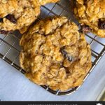 Baked old fashioned oatmeal raisin cookies on a wire cooling rack.