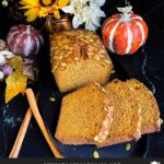 Baked better than Starbucks pumpkin bread, sliced, on a dark platter.