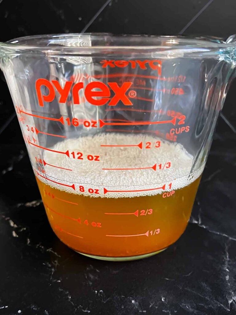 Melted brown butter in a measuring cup.