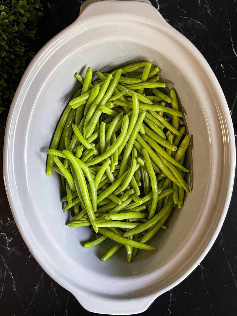 Raw green beans in a slow cooker.
