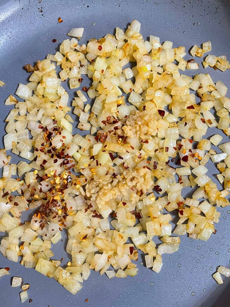 Onions sauteed in a skillet.