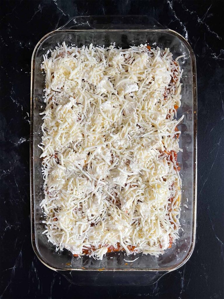 Mozzarella cheese sprinkled over the Romano cheese for baked spaghetti.