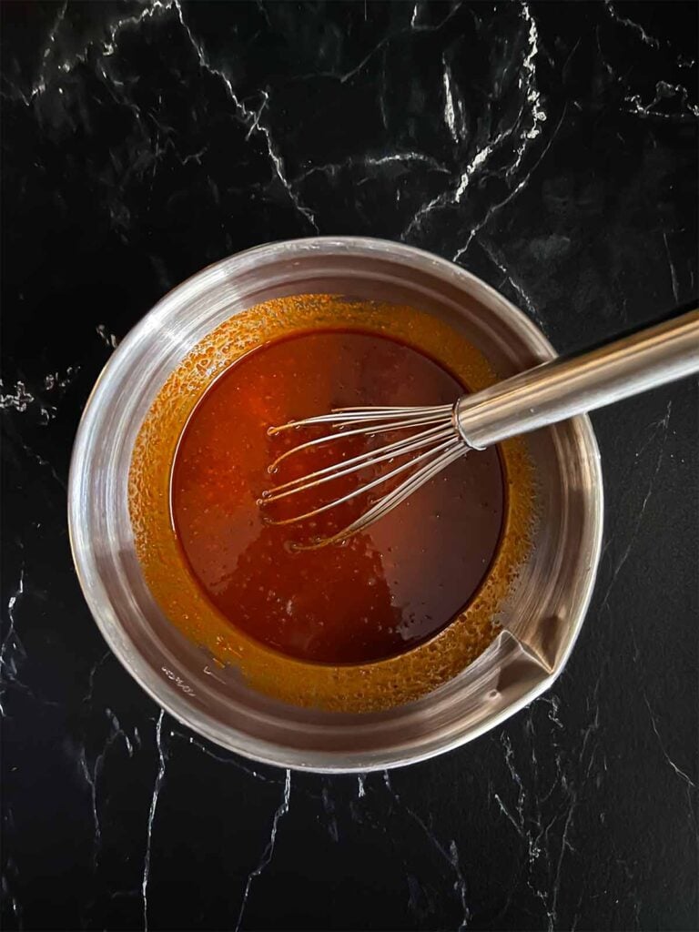 A gochujang marinade in a silver mixing bowl.