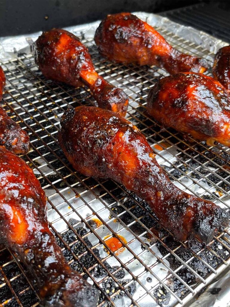 Gochujang chicken legs in the smoker.