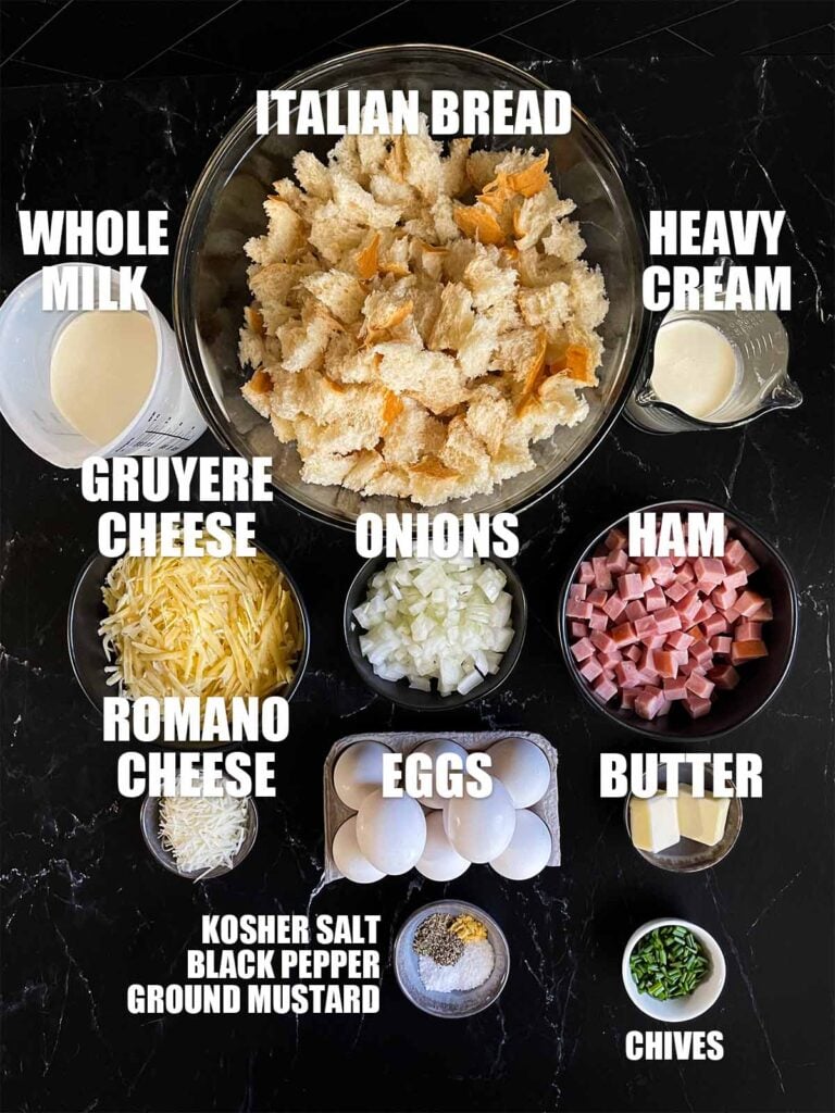 Ingredients for ham and cheese strata recipe on a dark surface.