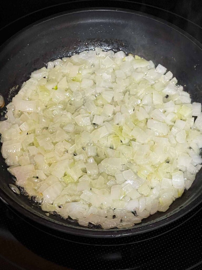 Onions for the ham and cheese strata sautéing in a small skillet.