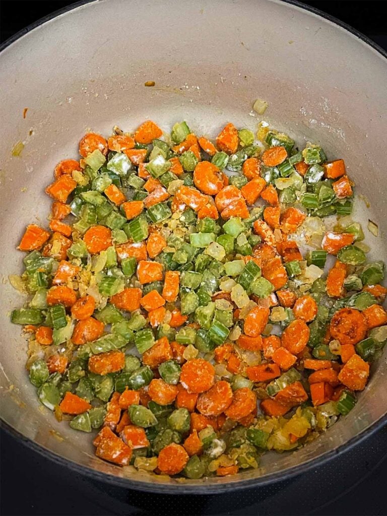 Flour cooking with mirepoix in a dutch oven.