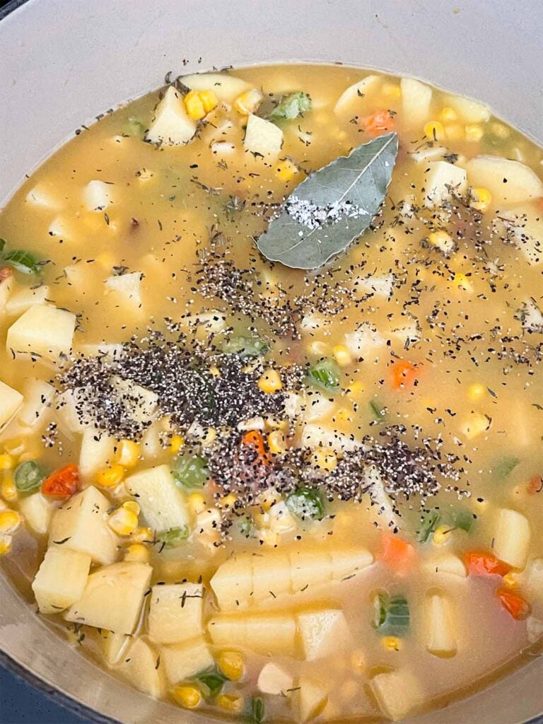 Ingredients for potato corn chowder in a dutch oven.