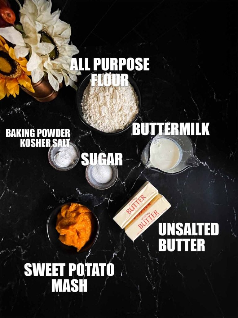 Sweet potato biscuits ingredients on a dark surface.