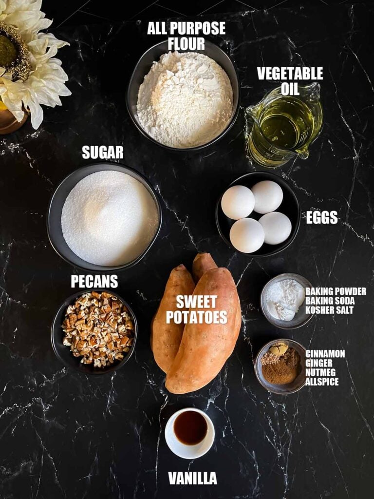 Sweet potato cake ingredients on a dark surface.