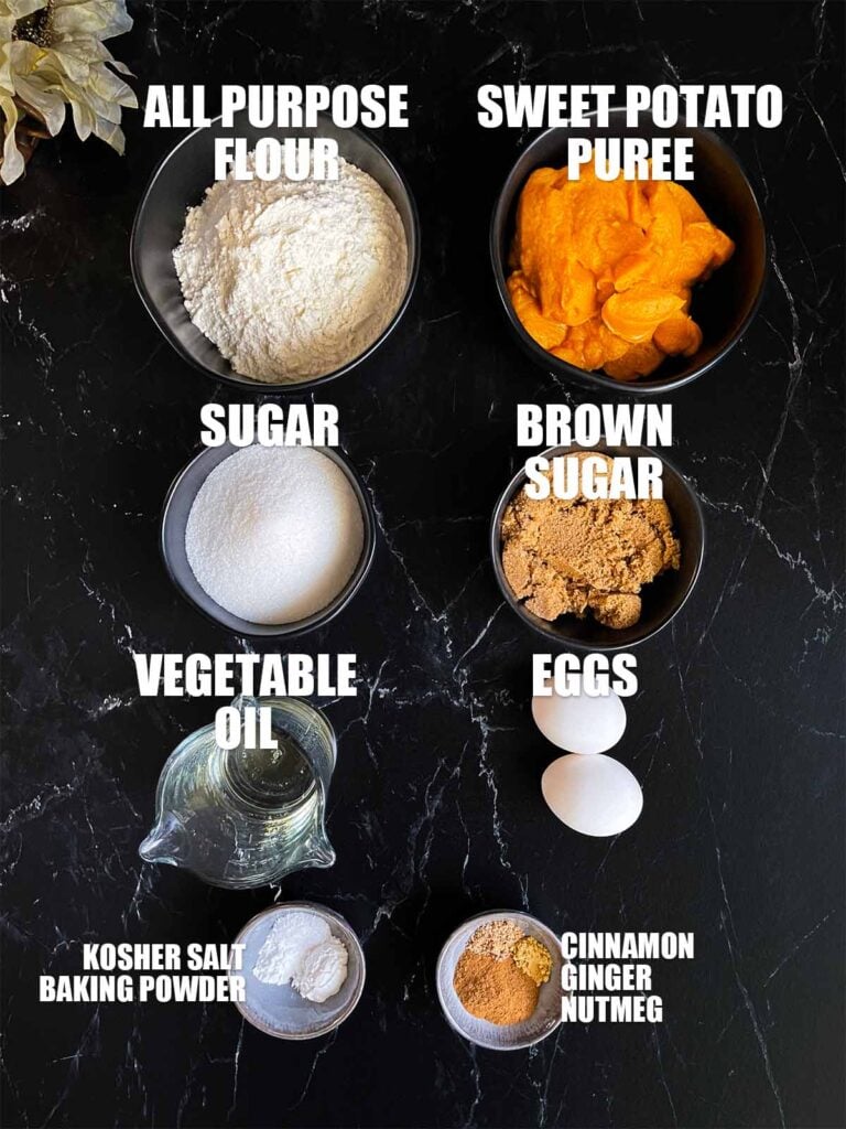 Sweet potato muffin recipe ingredients on a dark surface.