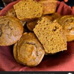 Sweet potato muffins in a cloth lined bread basket on a dark surface.