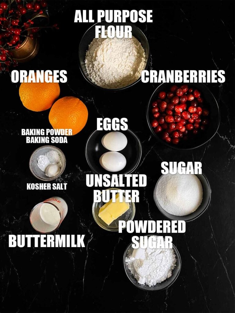 Ingredients needed for Cranberry Orange bread on a dark surface.