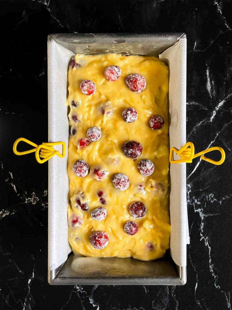 Cranberry orange bread batter in a loaf pan, unbaked.